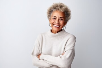 Medium shot portrait photography of a satisfied Brazilian woman in her 70s wearing a cozy sweater against a white background 