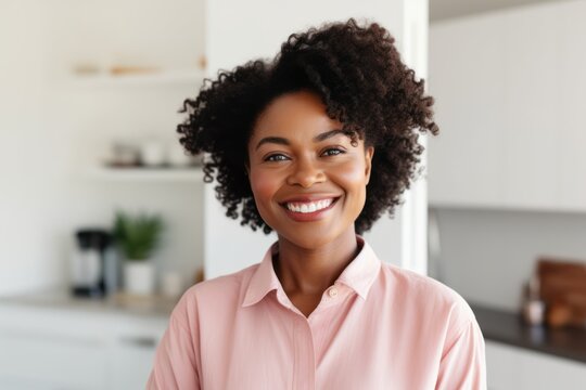 Portrait of a smiling young african american woman standing at home