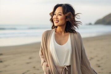 Portrait of a beautiful young asian woman smiling on the beach