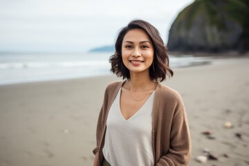Portrait of a beautiful Asian woman standing on the beach and smiling