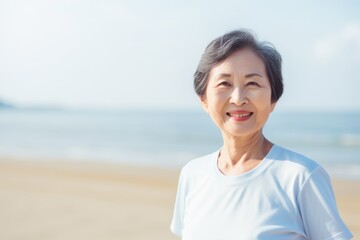 Portrait of senior asian woman in sportswear on the beach