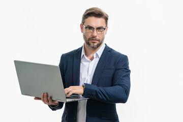 Millennial man in suit working on laptop in studio. Hispanic man checking information on laptop, typing information on laptop. Middle aged man searching information on laptops.