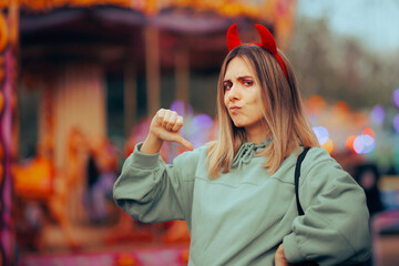 Mean Selfish Woman Wearing Devil Horns Pointing to Herself. Self-centered person thinking about...