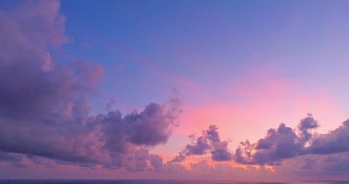 aerial view beautiful purple cloud in pink sky at horizon above the sea..Clouds obscured the pink sky in the evening background for creative nature .and travel concept. sky texture.