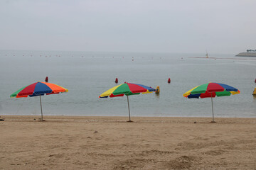 Colorful umbrellas on overcast beach