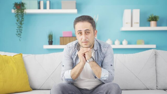 Man apologizing looking at camera.