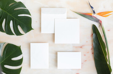 Styled summer wedding desktop stationery mockup. Blank greeting and invitation card. Green tropical leaves with empty space.