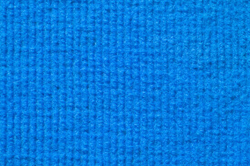 a detailed and close-up simple background of a blue furry cotton fabric with rows of hairs in the texture, space for text