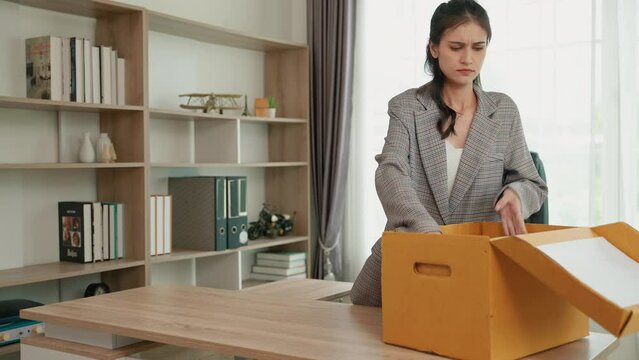  office worker who was fired from his job is packing things out of the office.
