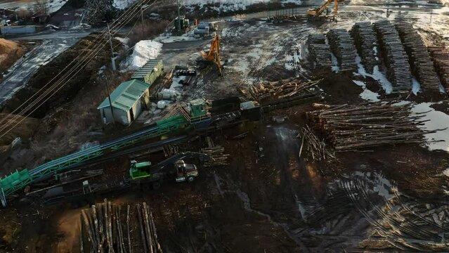 Drone view of logging equipment in Canadian winter landscape