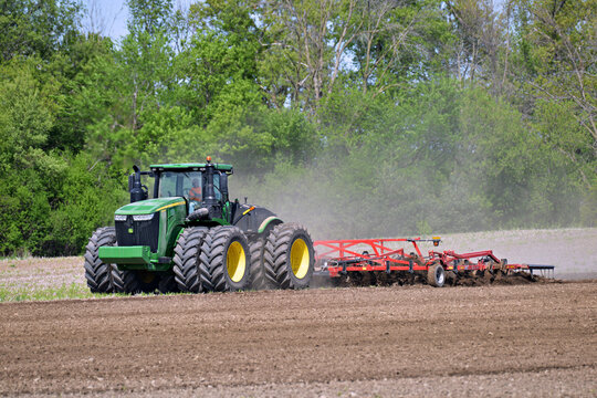WAUPON; WISCONSIN - May 15, 2023: John Deere 9470R tractor pulling a Wil-Rich XL field cultivator
