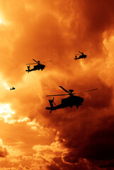 military helicopter in formation with dramatic sky