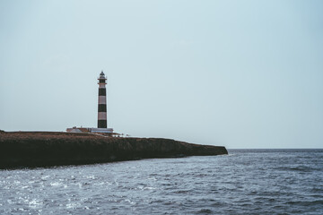 Fototapeta premium Beautiful blue white lighthouse on the Spanish island of Menorca