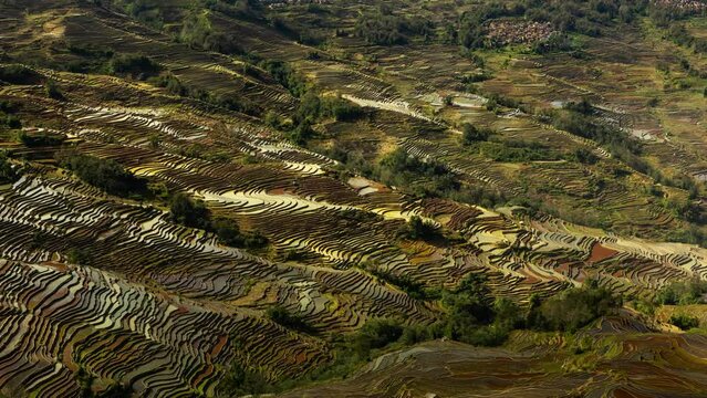 Time lapse looking down at the hundreds of layers of terraced rice fields in Yuanyang China.