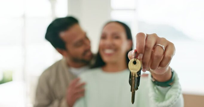 House keys, love or happy couple kiss for real estate, property investment or buying apartment. New home blur, hand or closeup of man hugging a woman to celebrate goal, success or moving in together