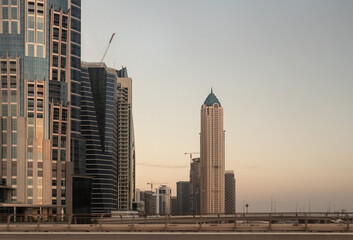 Fototapeta na wymiar View at sunset from the window of a tourist bus on the architecture of the city of Dubai, United Arab Emirates