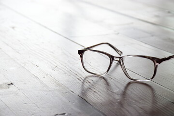 Reading spectacles on a wooden table