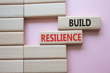Build resilience symbol. Wooden blocks with words Build resilience. Beautiful pink background. Business and Build resilience concept. Copy space. - obrazy, fototapety, plakaty