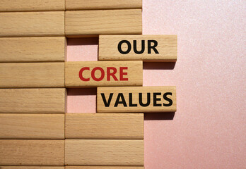 Our core values symbol. Concept words Our core values on wooden blocks. Beautiful pink background. Business and Our core values concept. Copy space.