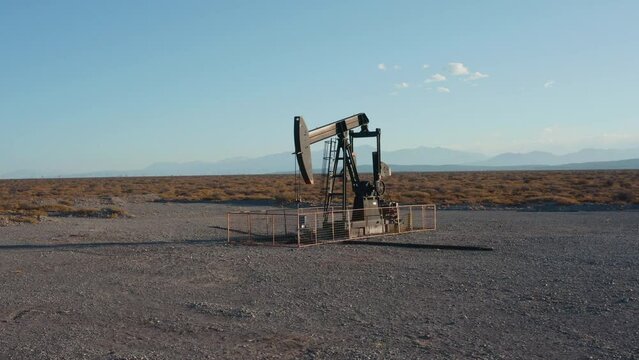 Aerial shot of working pumpjack extracting petroleum to the surface. Oil production in Mendoza Province, Argentina