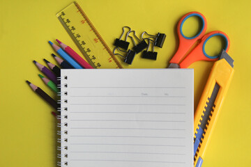 lots of stationery and notepads on yellow background