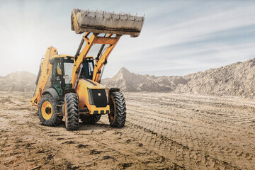 Wheel front loader or bulldozer at a construction site in a quarry. Powerful modern equipment for earthworks. Construction site. Rental of construction equipment.