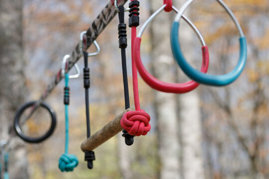 Recreational exercise hoops and bars hanging on a line outdoors