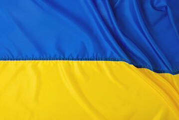 Ukrainian flag banner, yellow blue folded silk fabric texture background. National symbol of Ukraine country, government. Independence day, freedom concept. Template with copy space