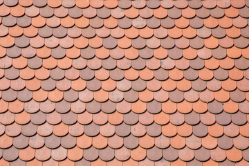 Red tile roof clay tiles roof of a private house made of shingles - obrazy, fototapety, plakaty