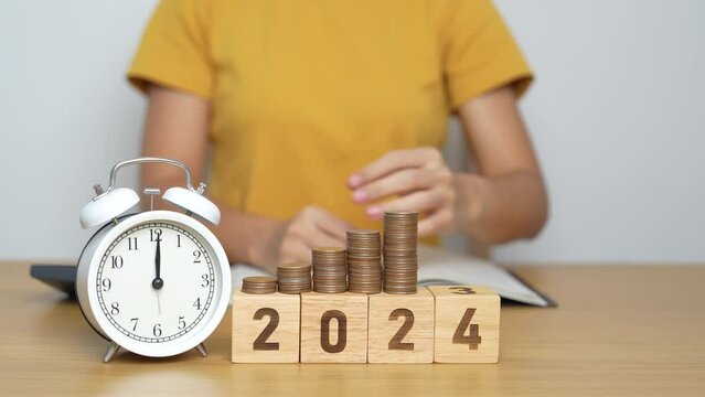 Happy New Year with vintage alarm clock and flipping 2023 change to 2024 block. Resolution, Goals, Plan, Action, Money Saving, Retirement fund, Pension, Investment and Financial concept