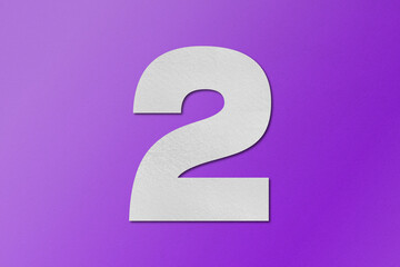 White paper type paper alphabet number 2 isolated on purple background.