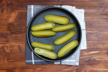 Pickled cucumbers close-up, snack. Selective focus. Ingredients for cooking on a wooden table