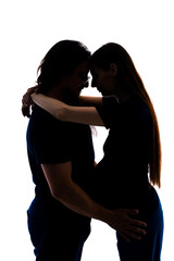 Photo of cheerful young man standing with his pregnant woman isolated over white background wall. beautiful young couple expecting baby standing together and touching belly 