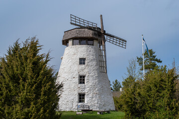 Kassari manor windmill on a cloudy summer day. A Dutch type windmill built in the middle of the...