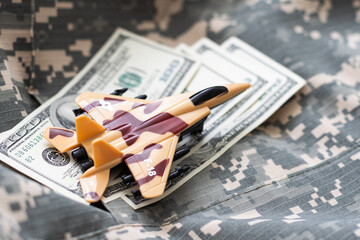 weapons on stacks of coins as a concept of the cost of military protection