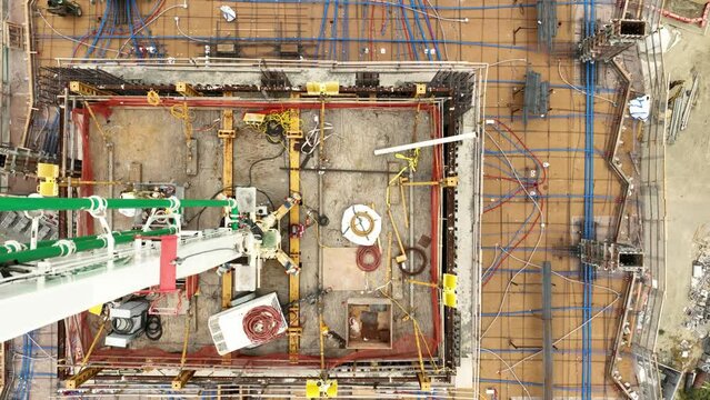 Aerial shot of a new high-rise building under construction on an overcast morning.