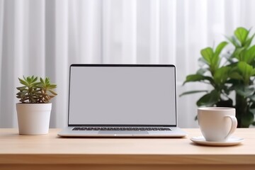 A laptop with a white screen mockup on top of a desk, a cup of coffee and minimalist room