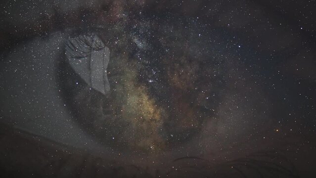 The human eye against the background of a moving starry sky with the Milky Way. Cosmic Mind. Artificial intelligence. Extraterrestrial intelligence