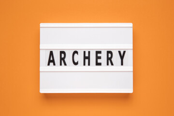The word archery on lightbox isolated orange background.