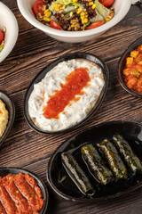 Different kinds of Turkish appetizers on white porcelain plates