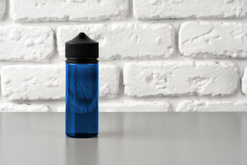 Refill liquid for electronic cigarettes against brick wall background