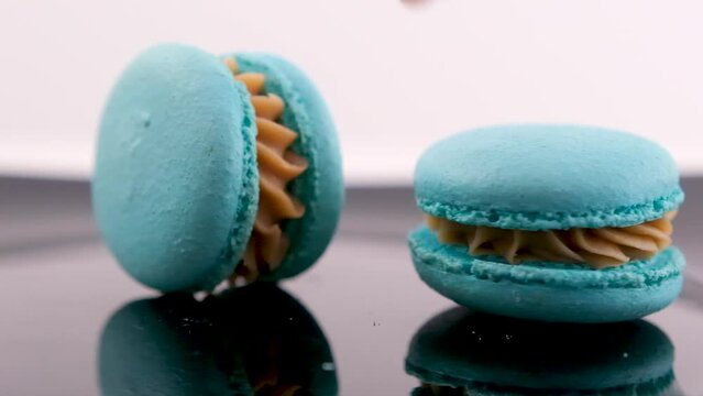 swirling blue macaron lavender or bru cheese flavor on black plate swirling delicious dessert restaurant serving sweetness french dessert lunch chef dish