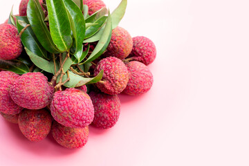 Lychee fruit on pink background.