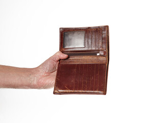 Men's hand holding leather wallet isolated on white background. Brown wallet in male hands