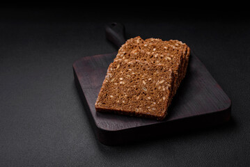 Delicious fresh crispy brown bread with seeds and grains cut into slices