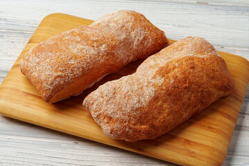 Two bread buns on wooden board close up