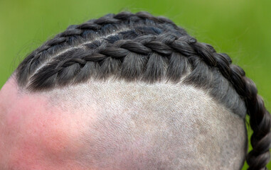 Hairstyle in the form of braids on the head of a man