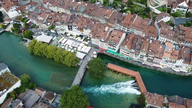 Thun, Switzerland: Aerial drone footage of the Thun medieval old town along the aar river in canton Bern in Switzerland. Shot with a tilt up motion