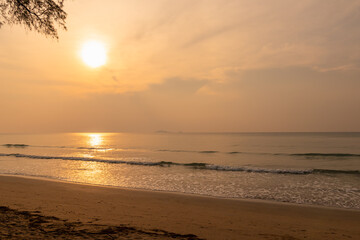 View of sunrise in the morning on the beach with golden sky.