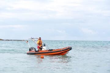 Lifeguard on a boat in the middle of the sea